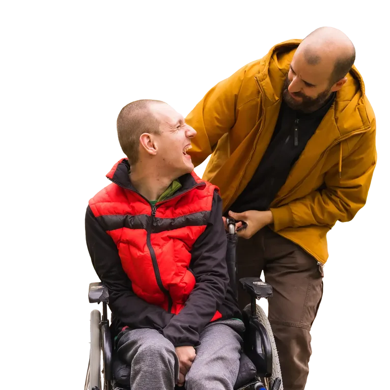 Male patient in a wheelchair sharing a laugh with his supervisor
